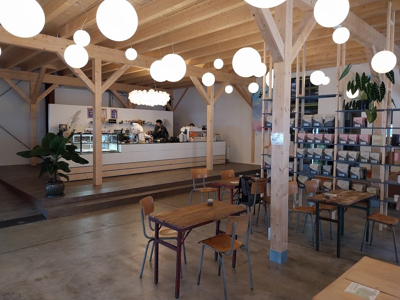 Tables, coffee shelves and the counter inside Heilandt in Cologne