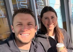 Jordan and Julia drinking coffee outside a café